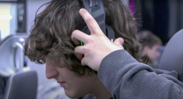 Hands on his headphones, senior Christian Alfano sets up his gaming equipment. Christian voices characters that appear in real video games that he plays in his esports management class. Im so proud of his grit, Christians dad Robert Alfano said. His experiences have been really unique to see.