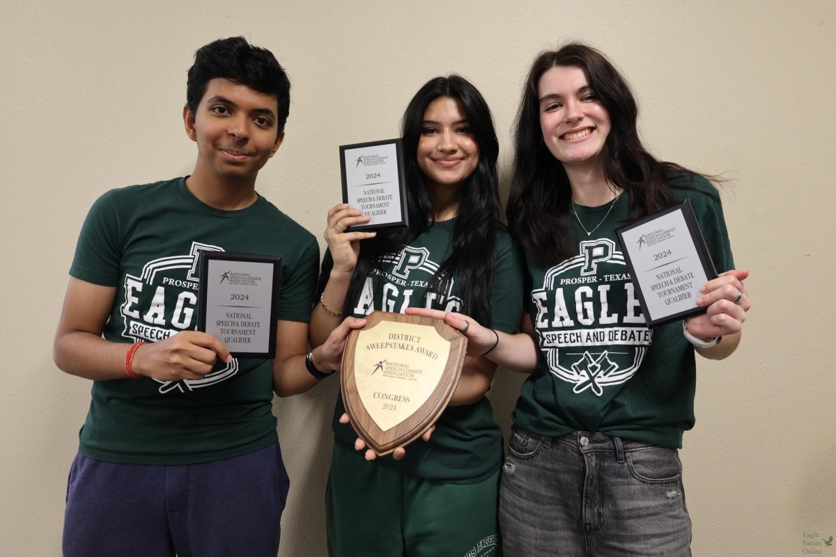 Holding up their national qualifier plaques, sophomore Tanish Chauhan, junior Avery Parker and Junior Mahnoor Waqas. They competed in congressional debate. In total there were nine national qualifiers. 