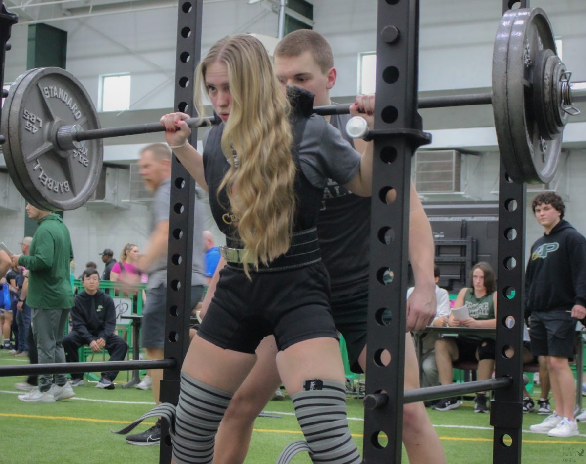 Senior Gabrielle Ocasio looks ahead for the signal to squat. Ocasio has been part of the Lady Eagles Powerlifting team for three years. The team placed third at the meet. 