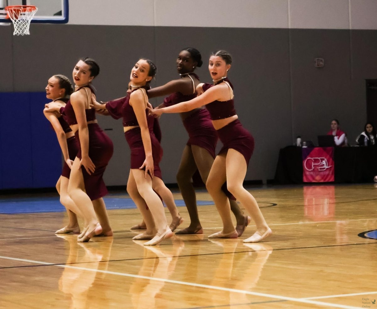 Looking to the side, Officers of the PHS Talonettes perform their dance. The officers are senior Brianna Marler and  juniors Nalla Hussain and Avery Mattox. The competition was held all day March 2. at Rockhill High School. 