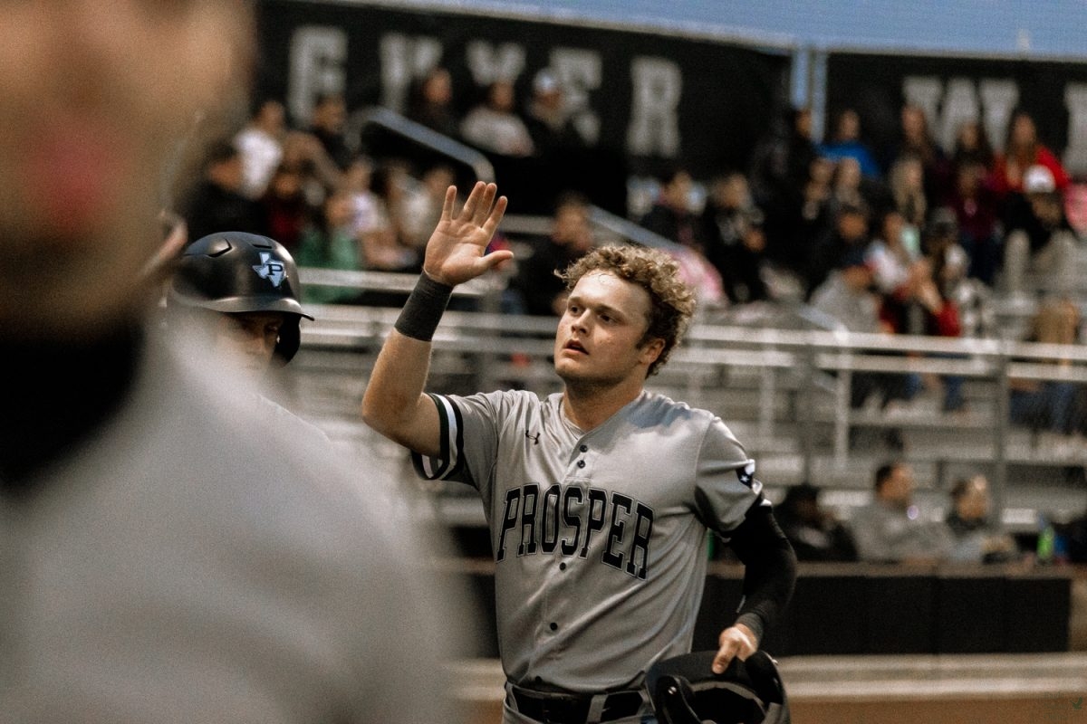 Hand raised, junior Kaden Kado Robardey celebrates a double run for the eagles. Due to assistance from teammate Erick Thompson, Robardey scored one of two runs during the first inning. Robardey played as one of the starting outfielders for the Eagles.