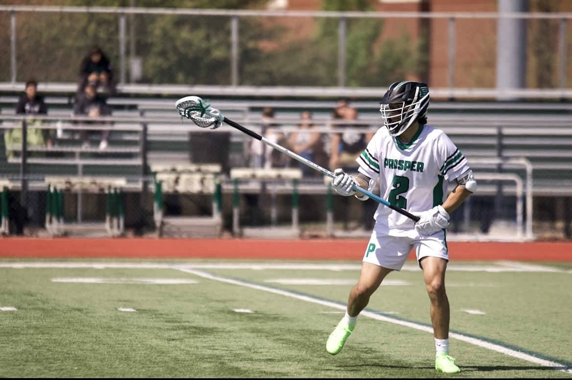 Stick extended junior David Androes hustles back on defense. Androes was awarded the WE award after the game. This award is given out to one player after each game, and represents the hard work put in by players and coaches to show the values of Prosper lacrosse. 