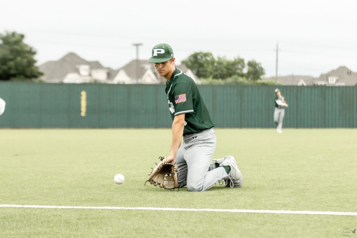As the ball rolls toward his glove, senior Cole Giametta warms up for the game against Allen High School. The Prosper Eagles won the first game on Tuesday April 16. The game took place at Prosper High School at 7:30 p.m. 