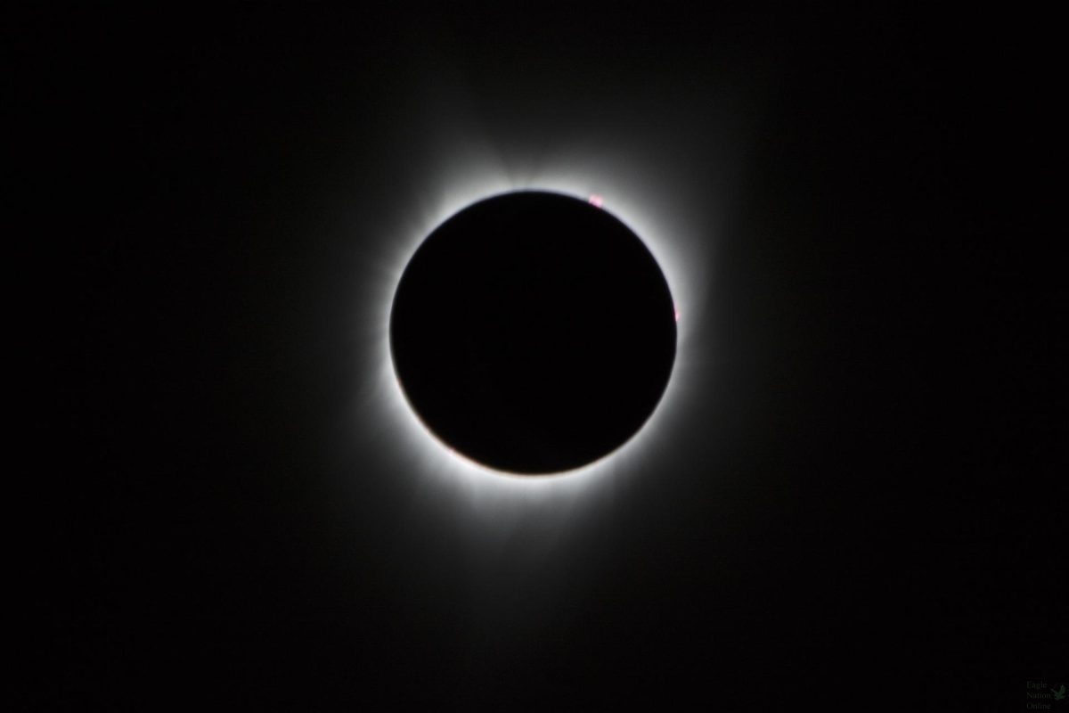 During the total solar eclipse, the Sun’s corona, only visible during the total eclipse, is shown as a crown of white flares from the surface. The red spots called Baileys beads occurs where the moon grazes by the Sun and the rugged lunar limb topography allows beads of sunlight to shine through in some areas as photographed from NASA Armstrong’s Gulfstream III. Photo and Caption Credit: (NASA/Carla Thomas) 