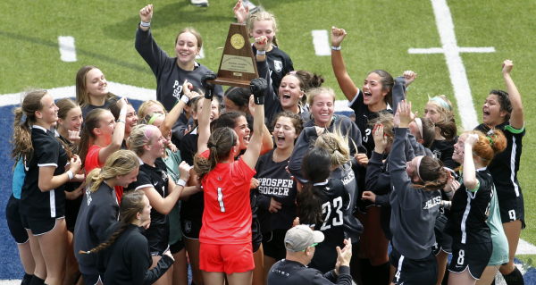 Trophy in the air, the Varsity Girls soccer team celebrates qualifying for state. The team beat Marcus on April 6. The team is selling t-shirts so click the link below to order one. 