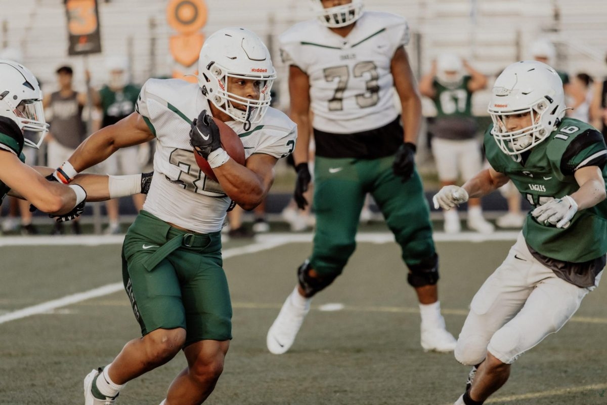 As he focuses on his next play, sophomore Jacob Martinez goes for a touchdown. He will be playing for the varsity team next year. All teams in the football program participated in the spring football game. 