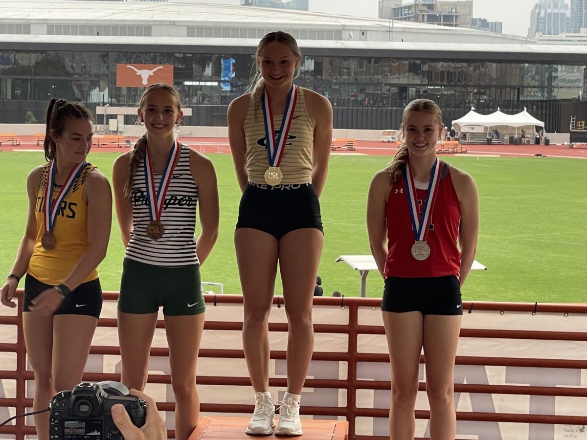 At+UT+Austin%2C+sophomore+Kate+Pemberton+celebrates+the+bronze+medal+at+the+UIL+State+track+meet+today.+Pemberton+competes+in+pole+vault.+She+completed+a+new+PR+of+12+feet.+