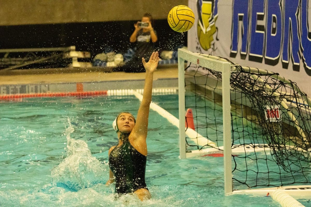 Reaching with one hand above her head, senior Hannah Lee successfully blocks another shot. Lee is the only senior girl on the varsity team, and has been playing water polo for four years. “I am eternally grateful for the experiences and memories Prosper Water Polo has given me,” Lee said, “And I will carry them with me throughout my life.” 