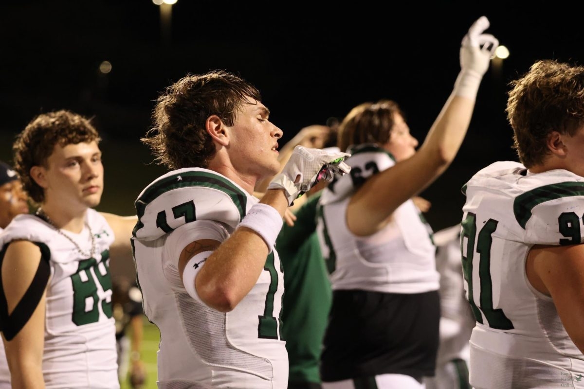 Taking a breath during the Alma Mater, junior Logan Thompson shuts his eyes and sings along to the music as the band plays. The game ended with a score of 42-16 and breaking Plano East's undefeated streak. The next game will be home against the Rock Hill Bluehawks at a game called "Battle Against the Birds," along with a Reynolds night, where eight-grade students in band from Reynolds can come to the game for free and interact with Prosper students in band and color guard.