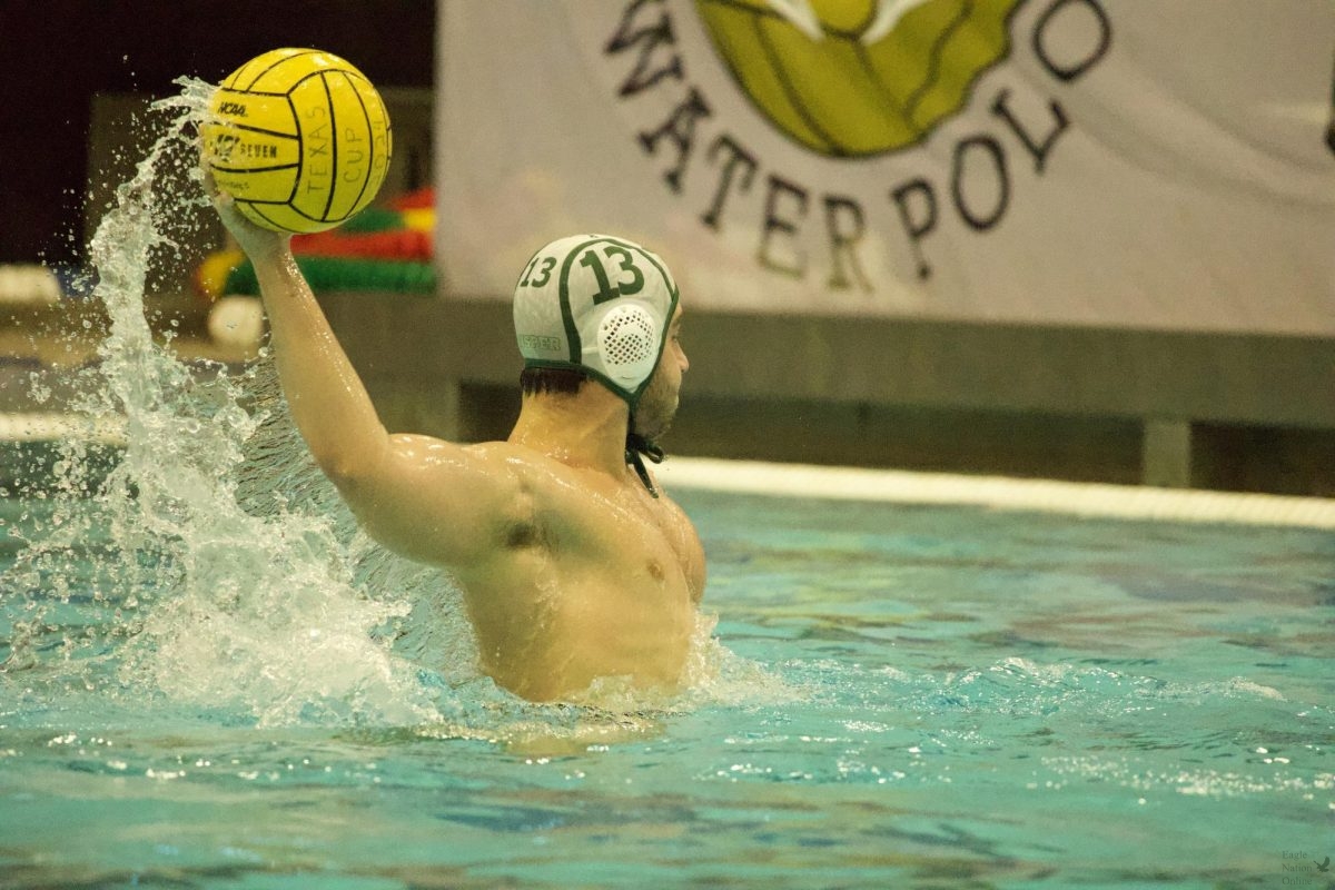 Ball in the air, senior Tyce Pierce on the Varsity Boys Water Polo team executes his next play. Pierce threw the ball into the back of the net in the middle of the third quarter. The varsity boys team played against Hebron at this game, and are ready for a rematch. “I like swimming,” Pierce said, “But when you incorporate a team aspect into it, it’s definitely more rewarding and more fun to win, and it’s definitely a better time overall when you have friends, as well as people you know playing the sport.” 