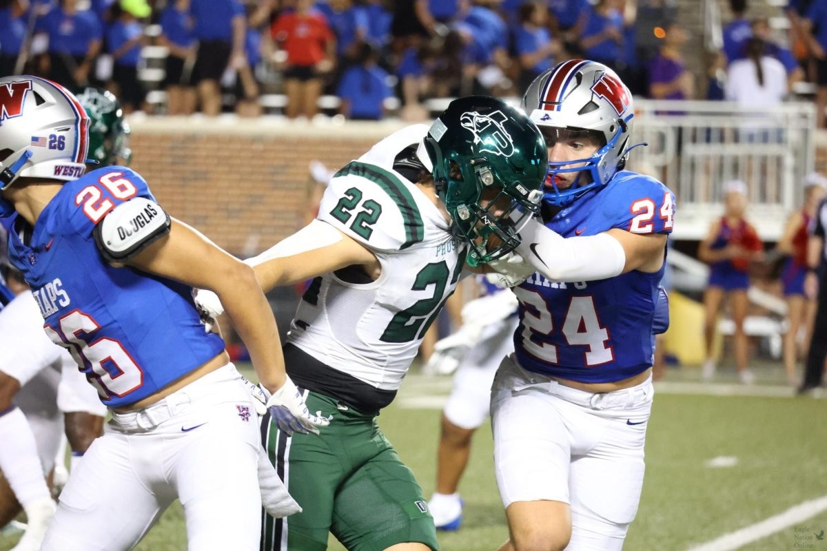 Breaking through their defense, junior Brady Harris gets through Westlake players to help his team in the fourth quarter. In the last few minutes, even when the team was losing, Prosper was able to push through. Prosper ended up with a loss 35-14.