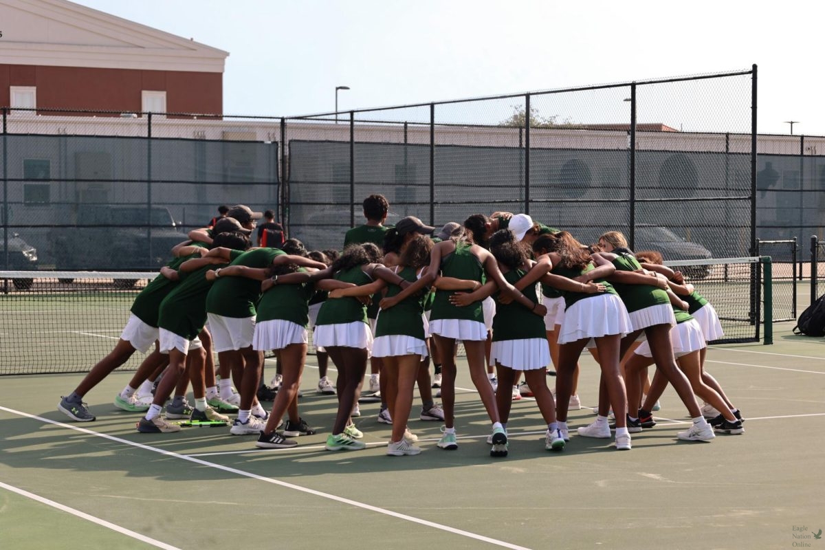 Huddled up, the Prosper tennis team "sets their spirit" for the game. The Eagles played against the Independence Knights. The game carried singles, doubles and mix doubles tournament.