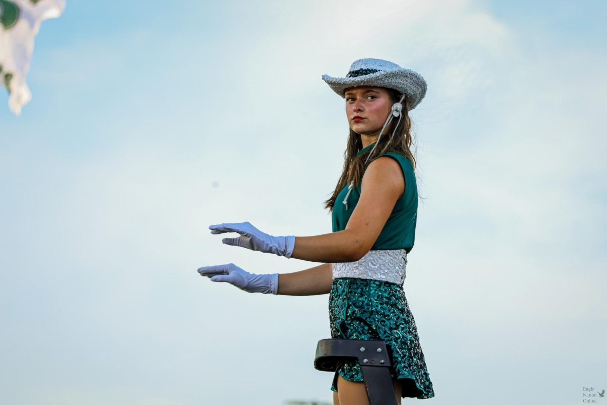 As she positions herself on the ladder, junior drum major and Talonnette Katie Lynn Sepper stands in front of the crowd and conducts the Prosper High School Might Eagle Band. This is Sepper's third year in the band and her second year on the dance team. "There are going to be hard things in life and you're not going to be able to do everything all the time. Just communicate," Sepper said. "The most rewarding part is inspiring others. 