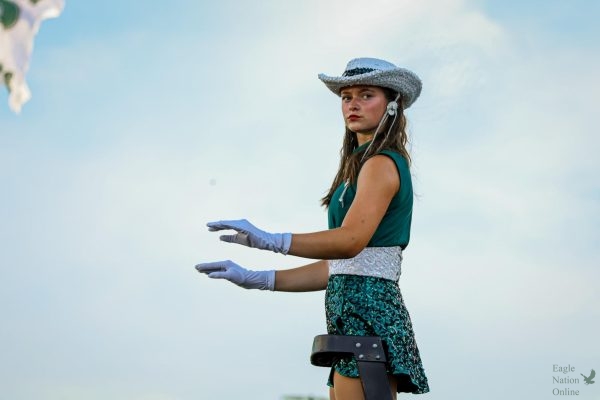 As she positions herself on the ladder, junior drum major and Talonnette Katie Lynn Sepper stands in front of the crowd and conducts the Prosper High School Might Eagle Band. This is Sepper's third year in the band and her second year on the dance team. "There are going to be hard things in life and you're not going to be able to do everything all the time. Just communicate," Sepper said. "The most rewarding part is inspiring others. 