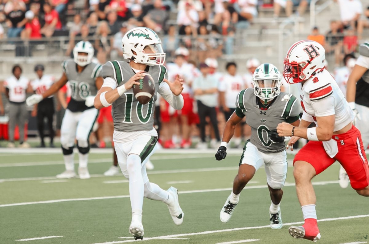 Sprinting away from a defender, junior Braedon Imhoff looks to throw the ball. Imhoff threw for 301 yards, earning five touchdowns. “We executed really well as a team offensively and defensively, everyone was making plays, and the energy was really high," Imhoff said. "We did not just play for ourselves but we played for our family and the whole ship."