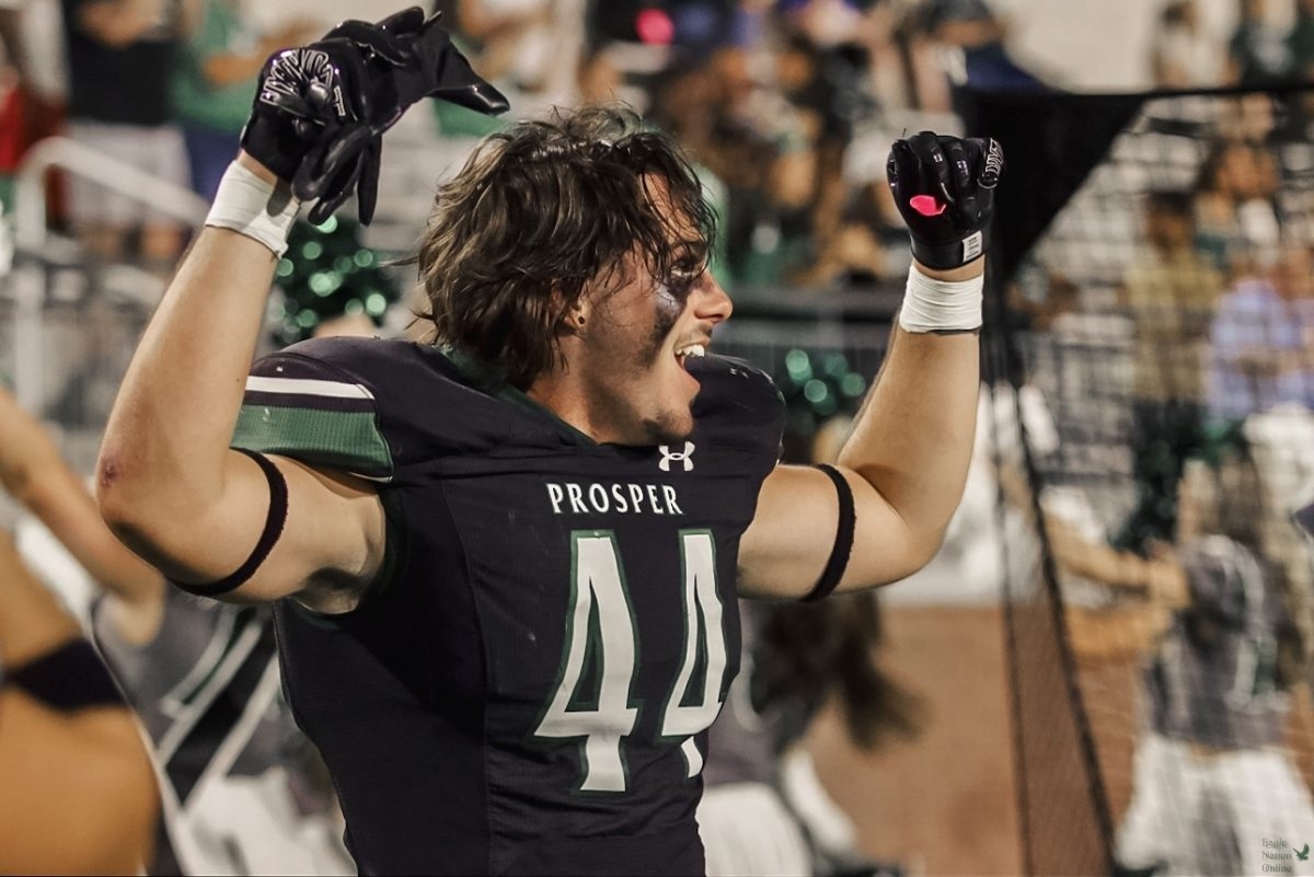 Hands up, senior Tayvin Labbe celebrates a Prosper touchdown in the fourth quarter.  Prosper defeated McKinney Boyd in 55-17 making them 1-0 in district play.