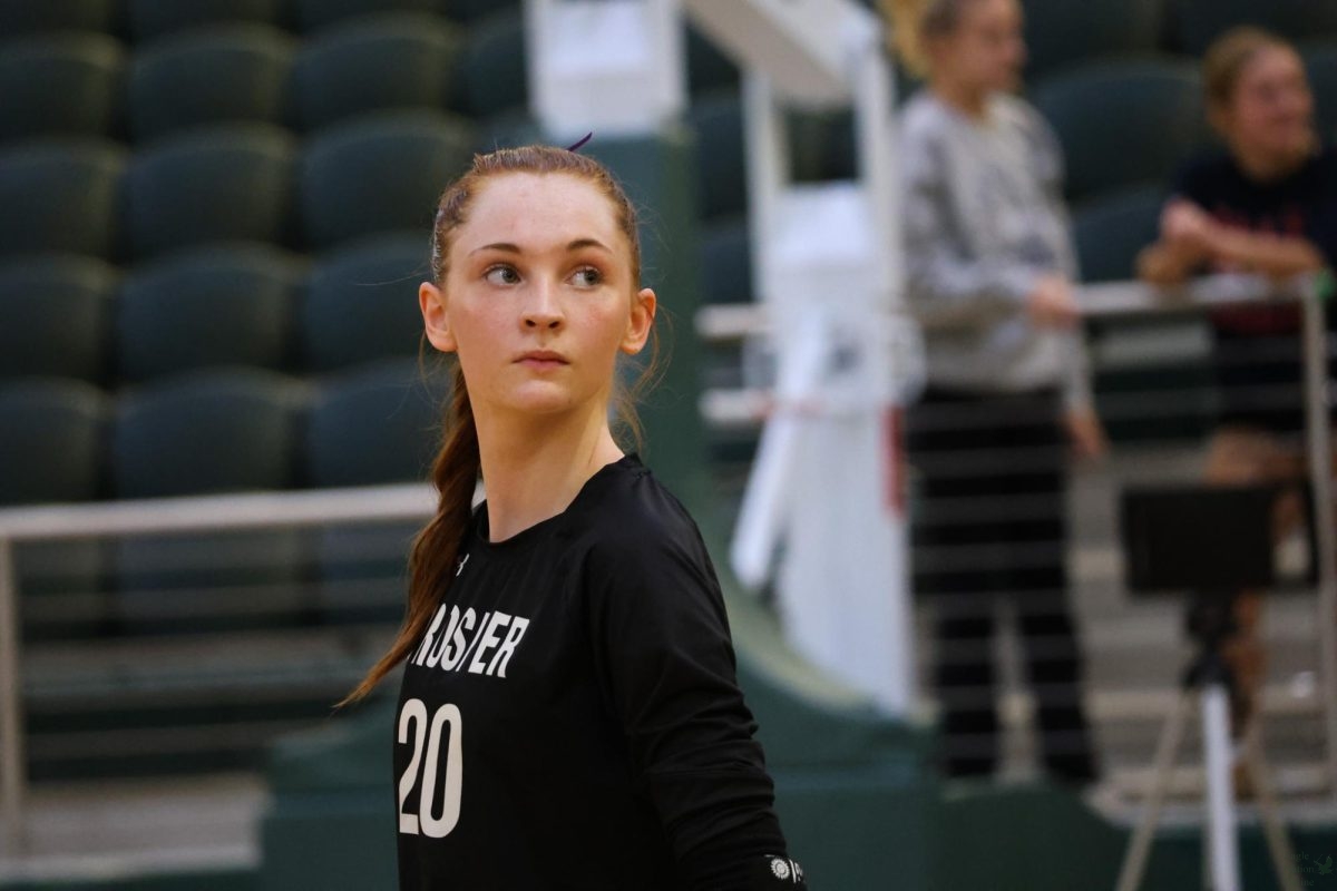 Eyes on the clock, senior Sophie Bridges focuses on the game. This is Bridge's fourth year in the volleyball program. She has committed to the Air Force Academy, where she will play on their volleyball team next fall. 