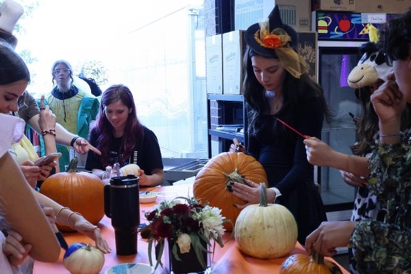 Brush in hand, senior Emma Esposito paints her pumpkin at the October FFA meeting held on Oct. 21. Emma competes in horse evaluation – a CDE competition. "You see horses going around and people riding them, and you have to judge them, and they have a mock competition," Richmond said. "And basically your goal is to get as close to the real judge as you can." 