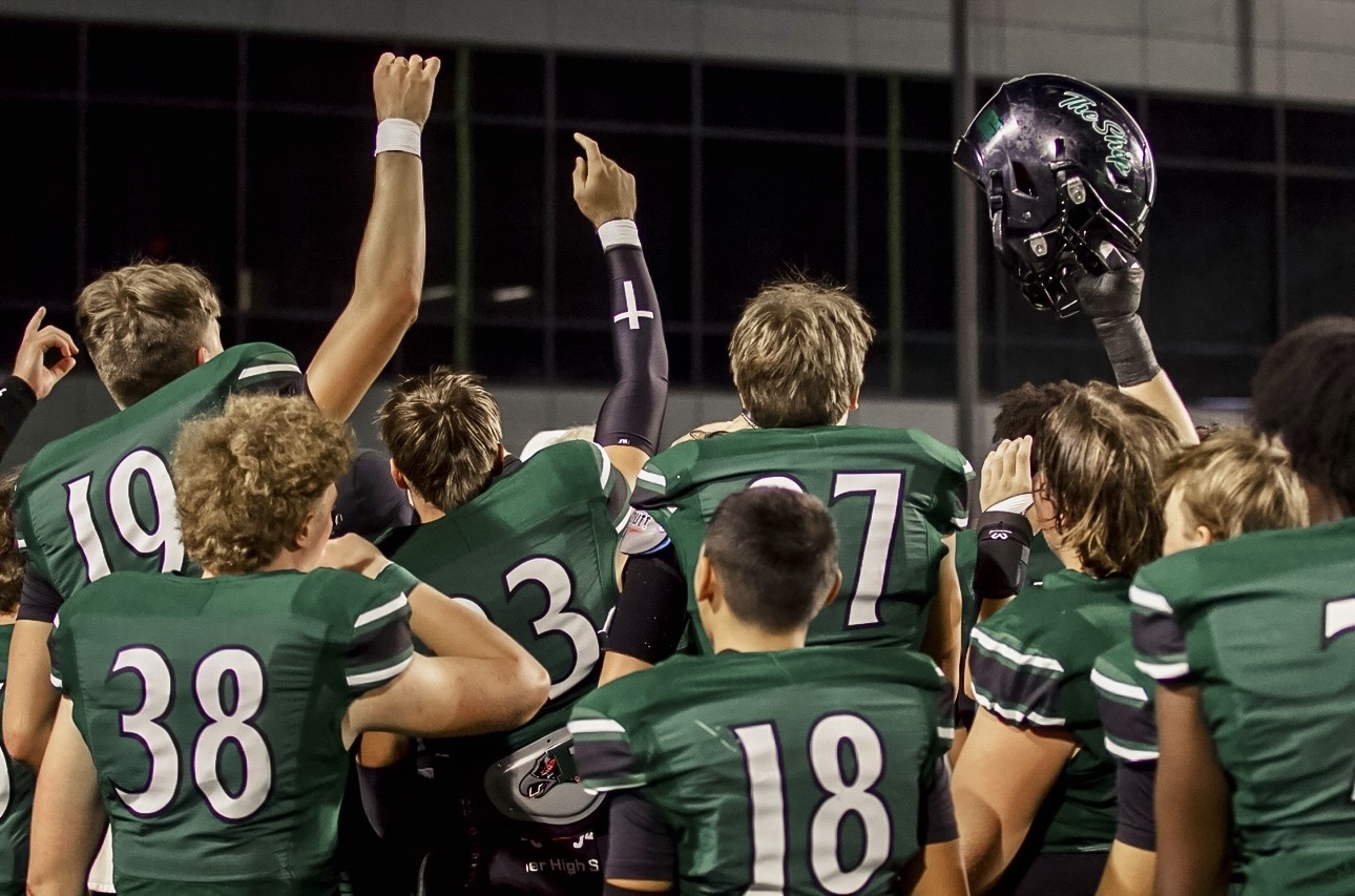 Helmet in air, the Prosper Eagle football team celebrates Coach Eric Mach's birthday after the win. The team is currently 3–0 in district play, ranking second. "We need to secure another district win to accomplish our goal of becoming district champions," senior Davis Carte said. "We've been preparing all week and if we keep producing like we have been I know we will."