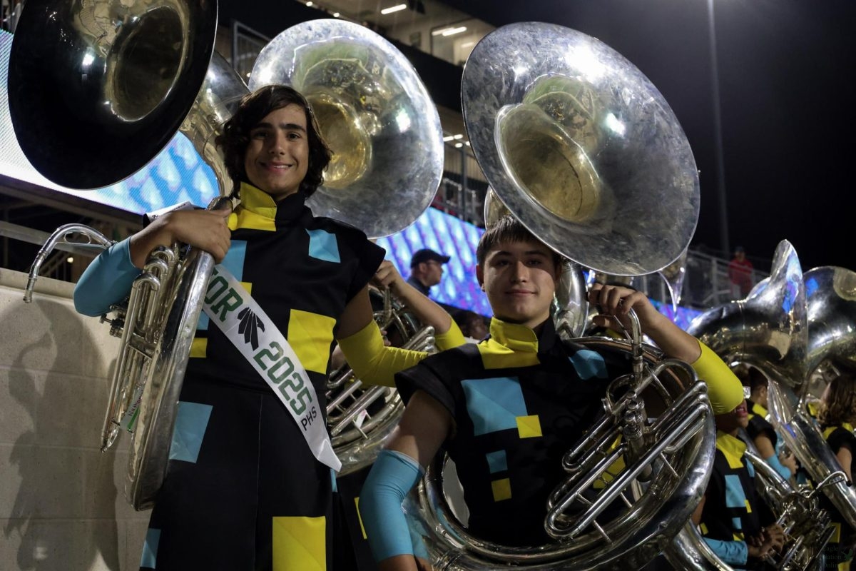 Side by side holding their sousaphones, senior Nathaniel Ray and sophomore Cameron Lovejoy endorse the time they have with each other. Ray wears his sash showing his desire for band throughout his high school years. The senior band members were recognized at the beginning of the game. 