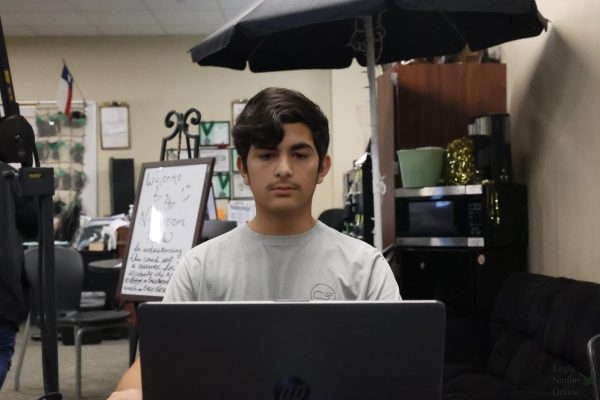 As he works on his computer, sophomore Mark Carbajal sits in the Eagle Nation Online classroom. He has helped achieve EagleNationOnline.com's 2024-2025 Site Excellence Badge.
"I strived to improve my work, going beyond the requirements of my graphic design assignments," Carbajal said. "[Soon] I had come to the decision that Eagle Nation Online seemed like the most interesting path to me."