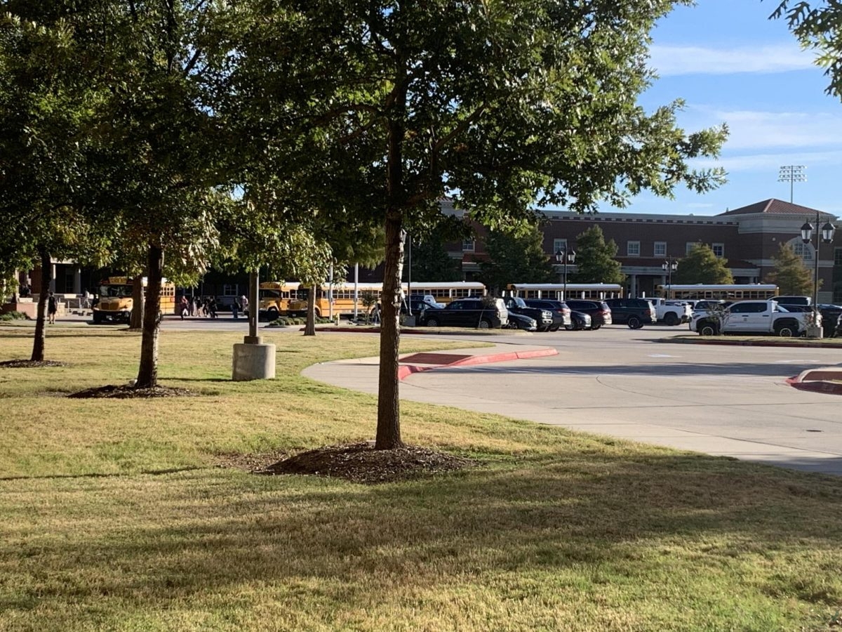 Overlooking the main entrance of Prosper High School, buses enter the parking lot in the morning. Bus riders arrive later than car riders, meaning that they don't experience the bad traffic other students do. "Traffic is not that bad because I ride the bus," sophomore John Cohorn said. "I'm there almost always on time."