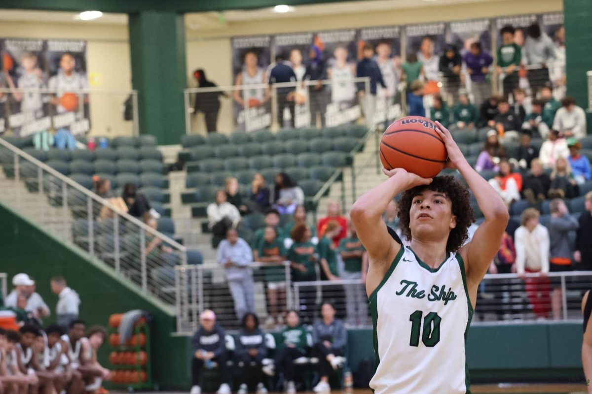 With his hands holding the ball above his head, junior J'Den Shields prepares to shoot a free throw. On Dec. 10, Max Preps ranked the boys varsity basketball team as No. 13 in Texas and No. 4 in the region. Head Coach Scott Imes leads the boys varsity team along with assistant coaches Ryan Lamberson, Gabe Owens, and Matthew Alford. 