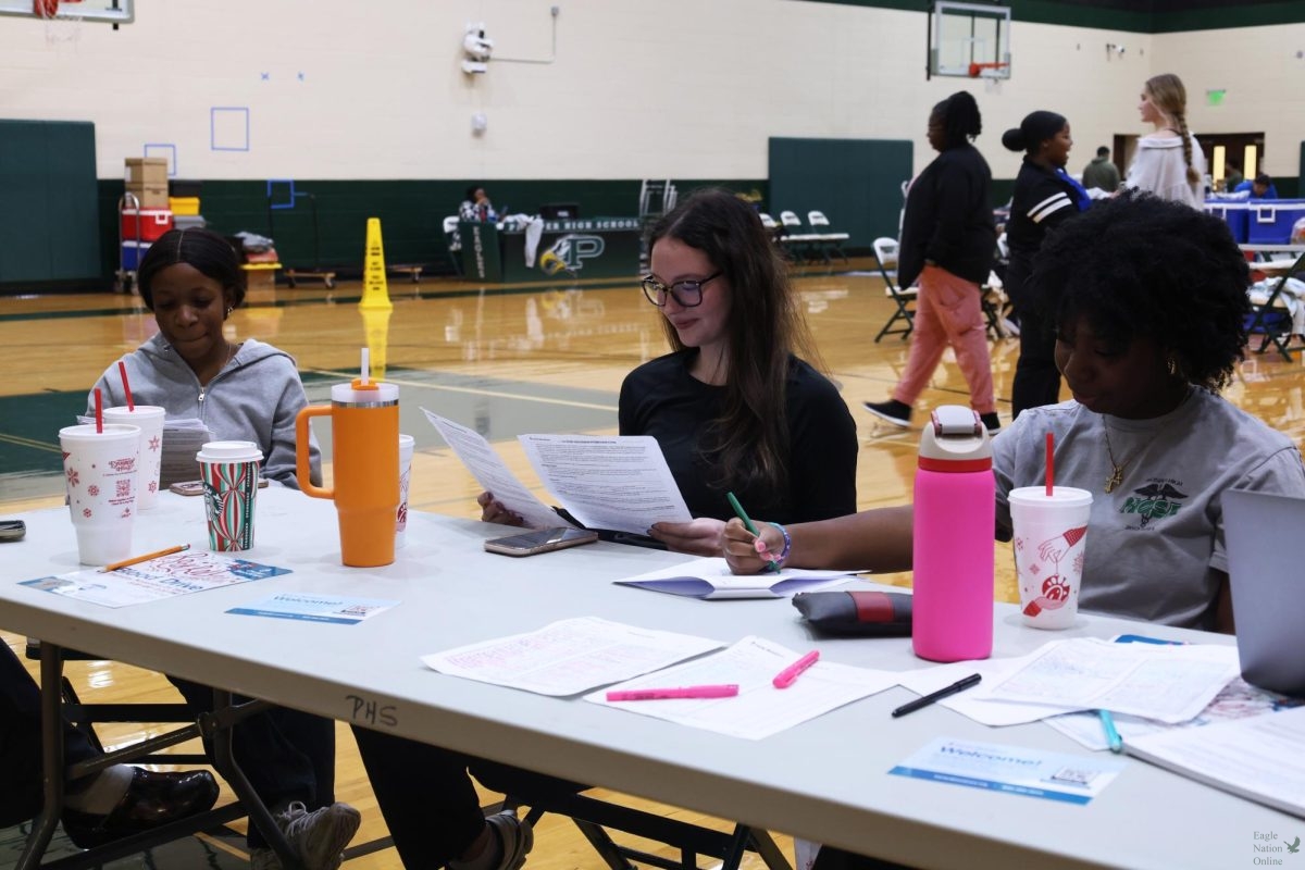 Waiting to check donators in, HOSA members work the blood drive they hosted before Thanksgiving break. The blood drive was located in Gym 1 and took place Nov. 21. "(The blood drive) allows people to donate blood for those who really need it, and so it's a really great thing that so many people come out and donate blood in order to help others," senior HOSA member Lily Lopez said. "It is really crucial for them."