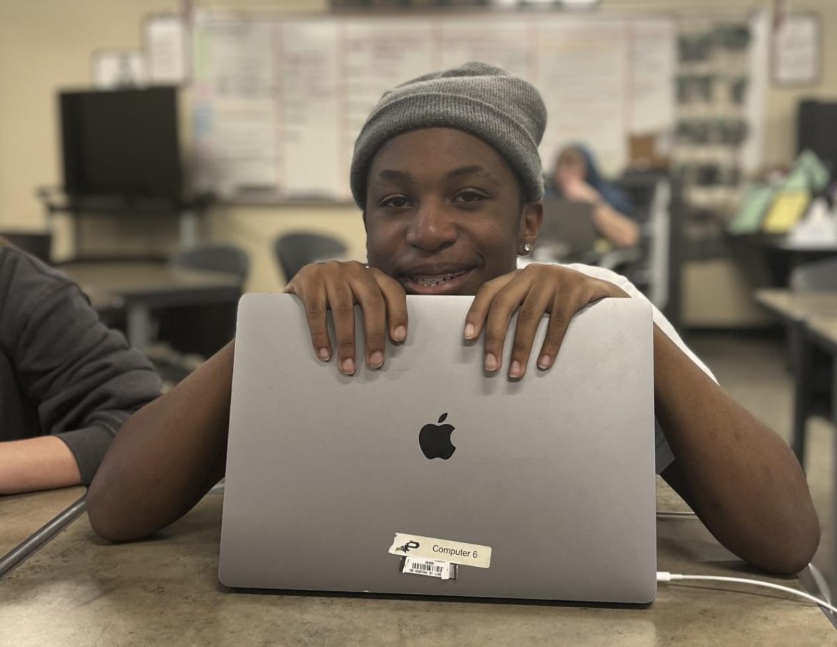 As he takes a break from his column, freshman Jah'siah Dennis stops to check in in with photographer and teammate sophomore Mark Carbajal. 
Before this picture, Dennis had been working on publishing the attached column. "You should never be scared to move schools," Dennis said. "A new place could always be better."