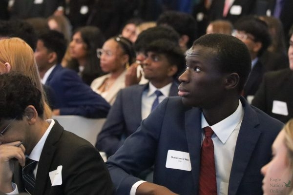 Just before eating lunch, PCIS 1 student senior Muhammed Njie listens to a speaker during the PCIS symposium at the National Toyota Headquarters. This year, Prosper High School offered PCIS 1 and PCIS 2 for returning seniors. The program is meant to help students improve their networking and interpersonal skills. 