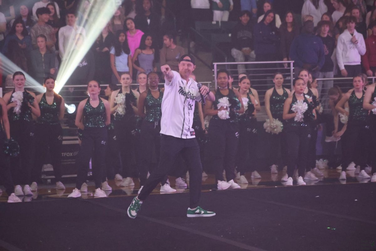 Arm extended, principal Nicholas Jones welcomes students to the 'Space Jam' pep rally. This was the last pep rally of the year. The event took place in the PHS Arena during advisory. 