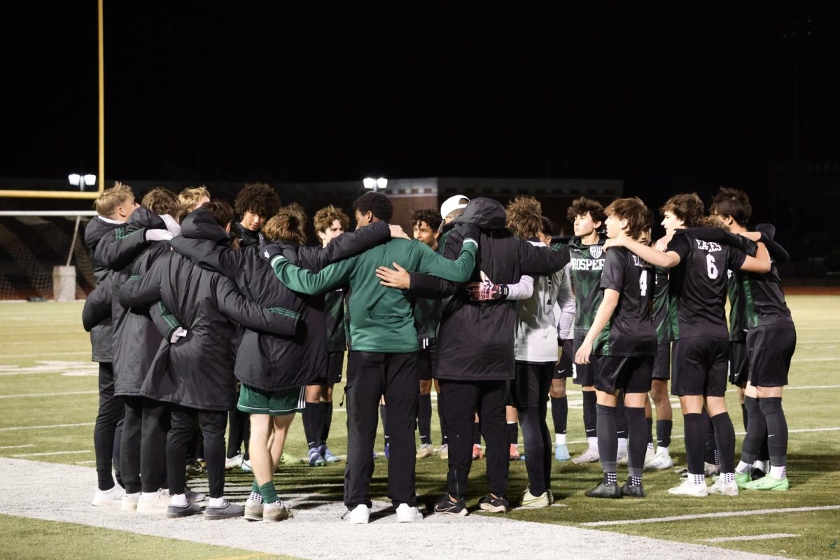 Huddling together before the game, the Prosper High School varsity boys soccer team prepares for their match against McKinney Boyd High School. The game is being held at the PHS Track and Turf. Their next game will be played away.