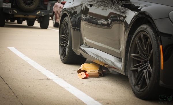 In the north parking lot near the MPF, a McDonald's bag lays under a car. This semester, students consistently left trash in the parking lot without picking it up. In a news article regarding the trash in the parking lots, Sgt. Chris Reeves brought awareness to the matter.  