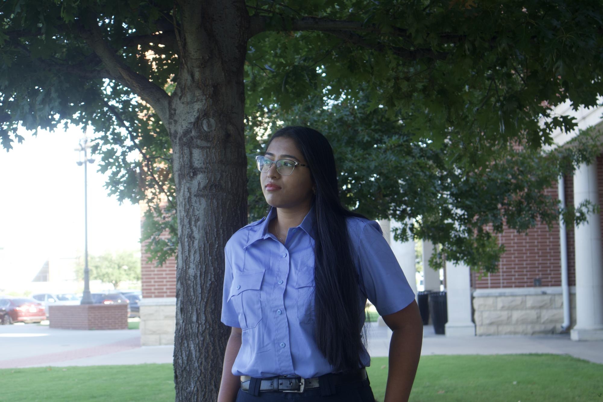 Looking off into the distance, senior Neeharika 'Lucky' Alapati stands outside Prosper High School dressed in her EMT uniform. Alapati plans to become an EMT once she graduates. "I'm probably going to go to college, maybe in Texas," Alapati said. "I think I'll try to practice as an EMT and get my pharmacology certification so I can start working."