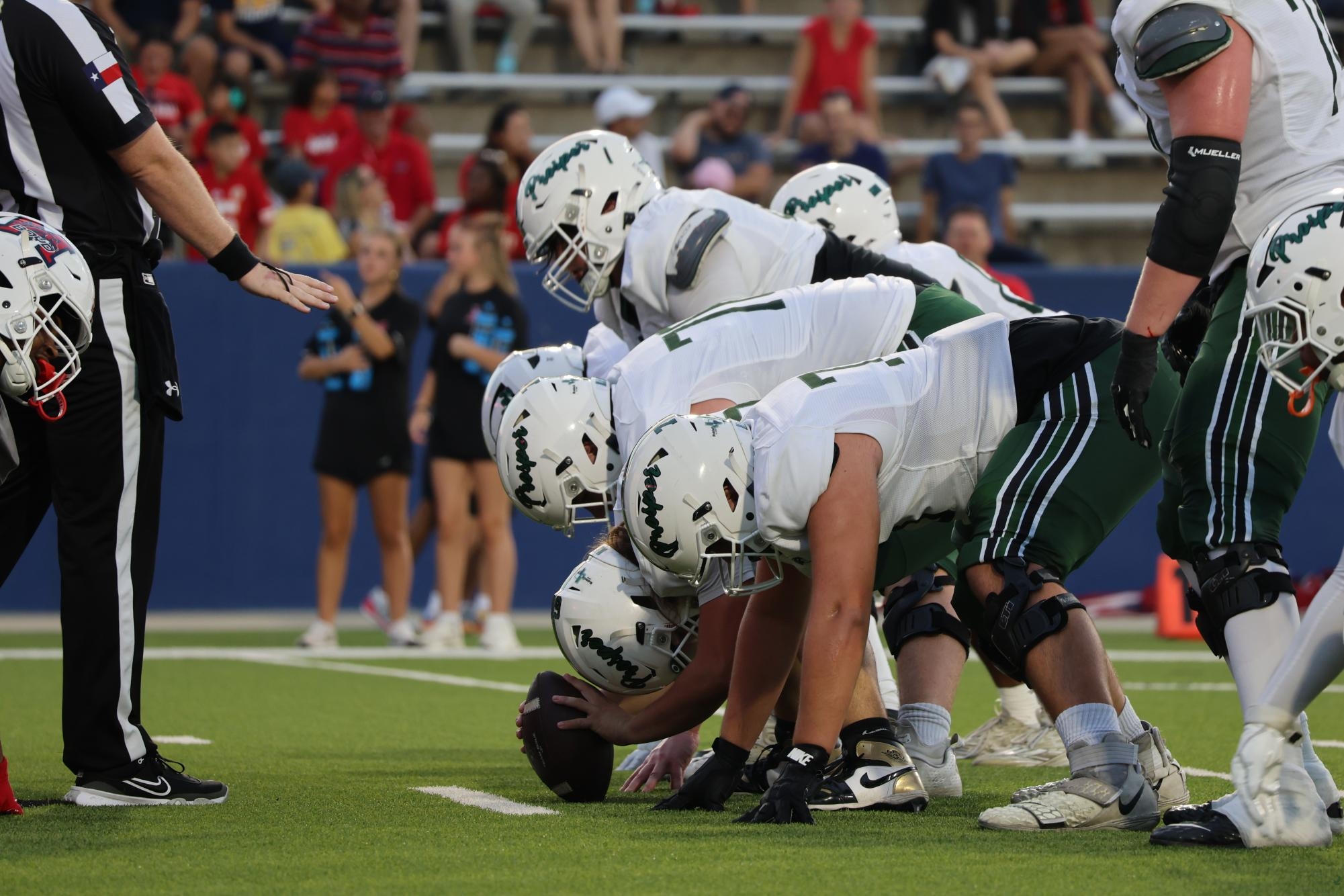 Set up for an offensive play, the varsity football players begin to ready to execute a move. The varsity football team has moved up in ranks and is currently 6th in the state. "The game's been great we've just went through a position that played extremely well," Principal Paige Trujillo said. "We got to shake some rust off from bye week and just get after the Broncos."
