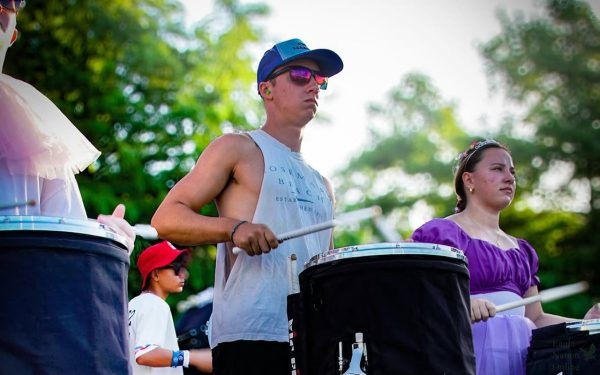 Standing with his drumsticks in his hands, junior Noah Scarborough performs for the audience. Scarborough is part of the Prosper High School Drum Line. “I really love drumming,” Scarborough said. “It’s a different type of experience.”