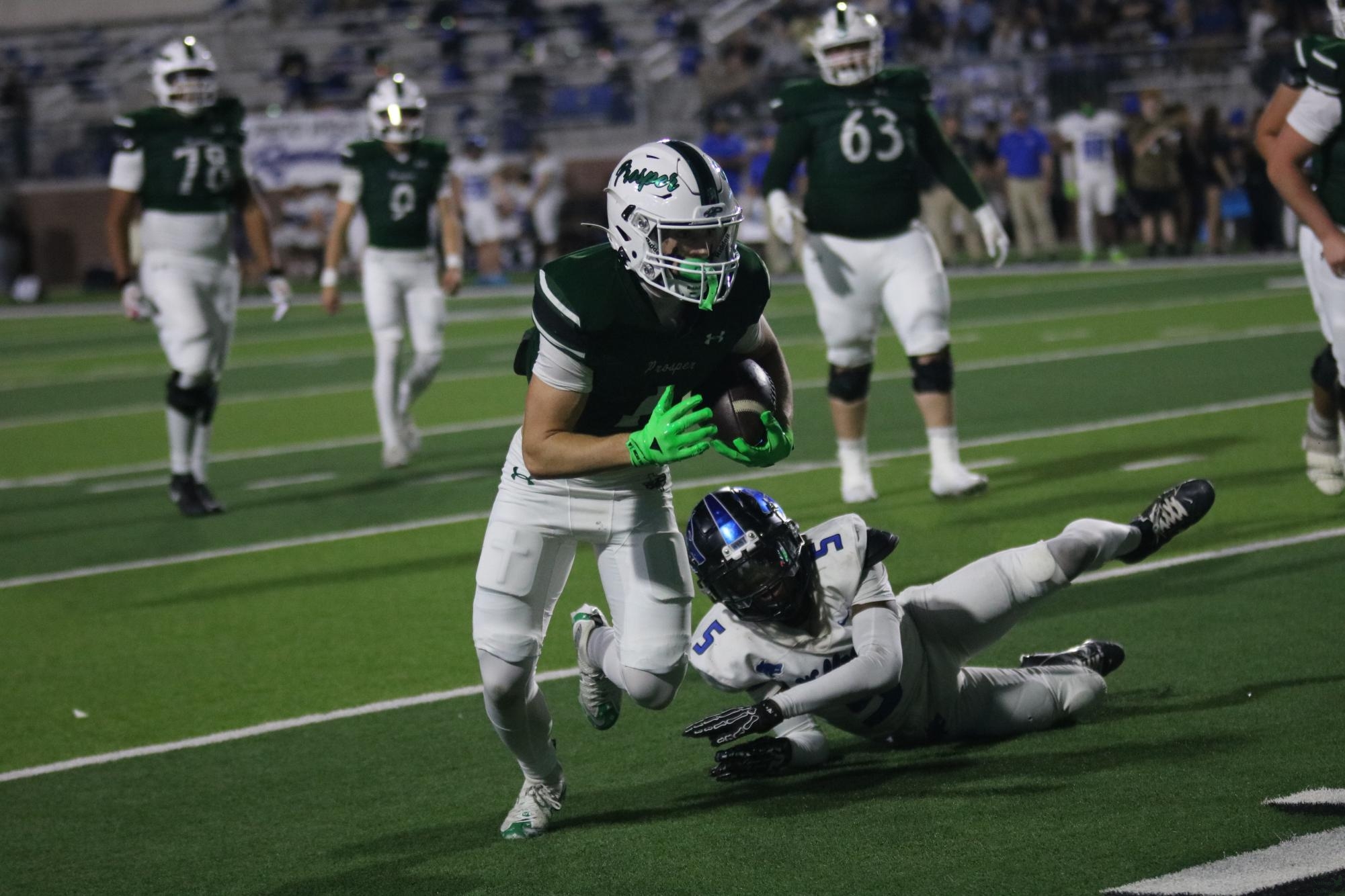 As he dodges a player, senior Lathon Latolais approaches the Prosper 10 yard line. Latolais is the wide receiver for the varsity football team. The game took place in the Children's Health Stadium. 