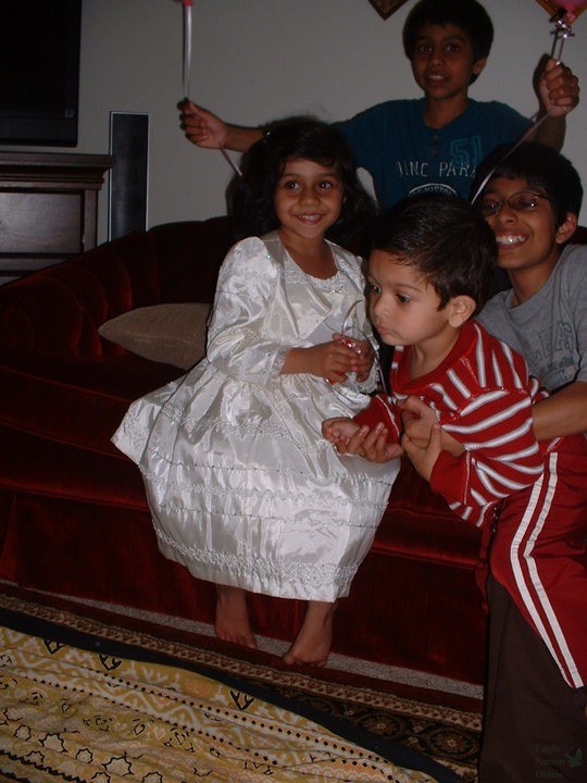 Held in arms, ENT Editor-in-Chief Yousuf Ali and his cousins sit on the couch posing for a group photo. "I'm so happy to have such a strong relationship with my cousins," Ali said. "till this day I get to hangout and play games with them" 