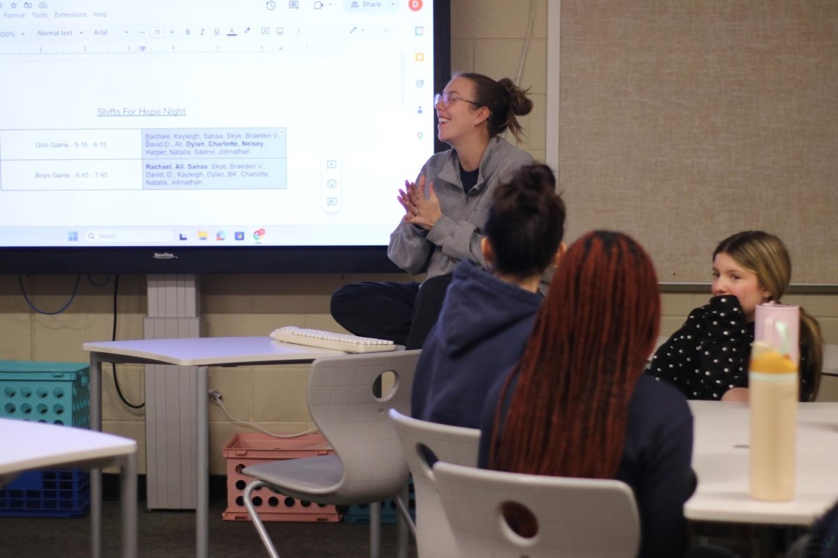 As she goes over the week's schedule, Hope Squad  Advisor Delaney Alford guides her class through the upcoming Hope Night responsibilities during a Wednesday meeting. Earlier in the period, students examined the Hope Night shift list displayed on the screen, organizing who would help at the girls' and boys' basketball games. "I joined to help friends in ways that others might not know how to,” freshman member Dylan Cahill said. “Hope Squad showed me how to actually do that."
