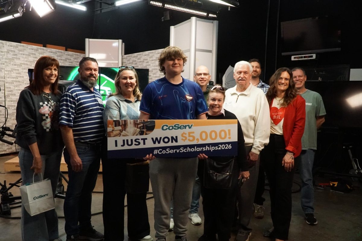 Surrounded by the principle, his counselor, his family and his close teachers, Colton Boston holds his award. Boston is part of ENN and stadium crew. "I can attest from personal experience, he's earned every cent," Hatch said. "He's going to put the scholarship to good use by helping people."
