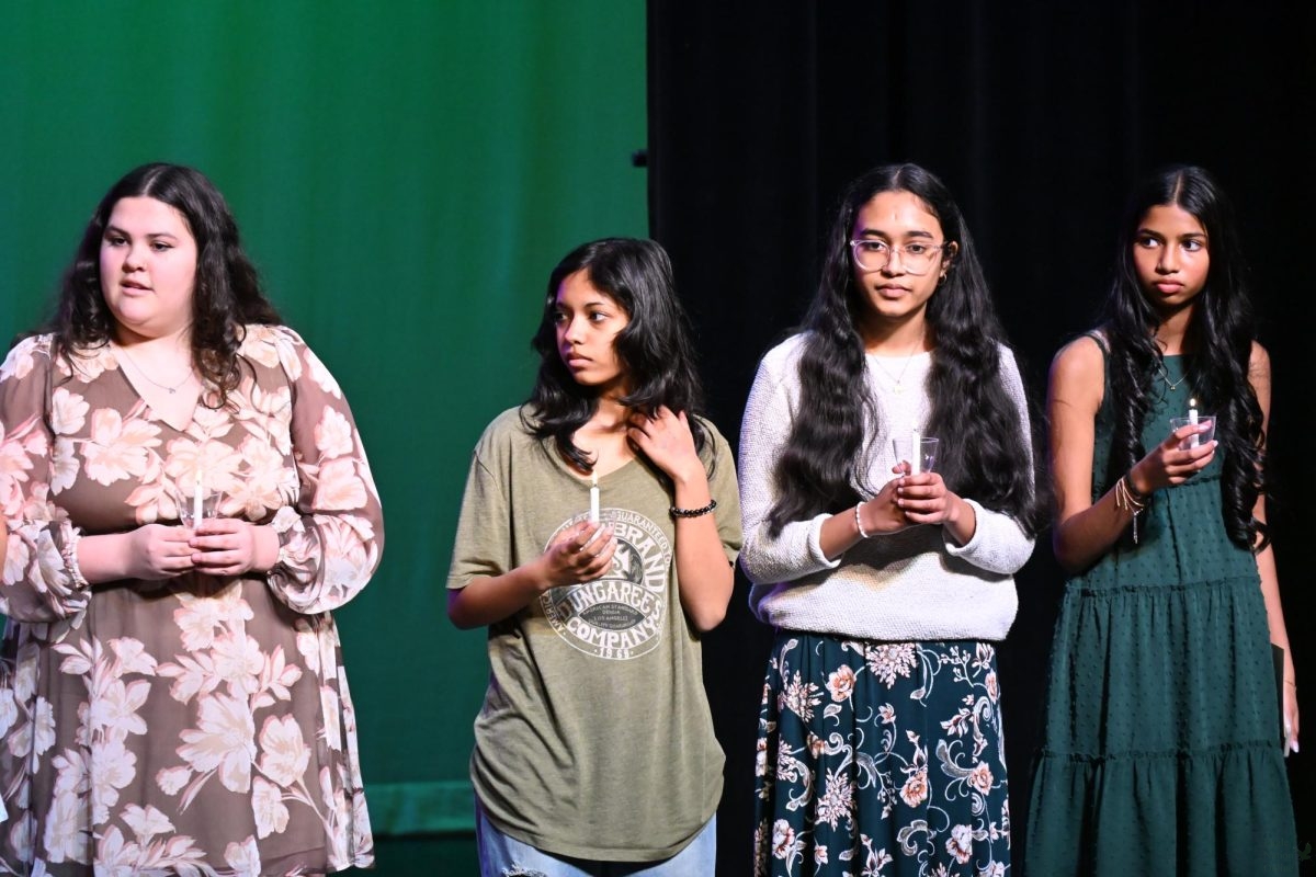 Waiting during the ceremony, senior Sydney Sanchez, junior Jissha Adithi Satheesh Kumar, sophomore Monika Shankar and freshman Shrila Srinivasan hold their candles during National Art Honor Society induction held Thursday, Feb 5. New NAHS inductees held lights in order to celebrate their new membership into the organization. "The NAHS induction was very exciting," Kumar said. "We got to light candles and that excites me."