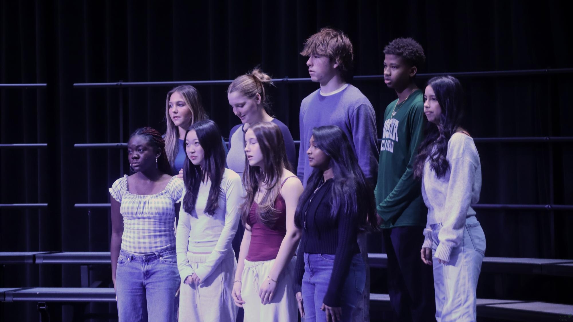 Waiting for their photo to be taken, members of the PHS Disciples club juniors Ella Mattox, Abigail Vanderwerken, Cameron Hall-Smith, Earl Moore, Sophia Landrith, senior Nelsey Nobosse Nken, juniors Charlotte Shin, Sydney Mlinarich and senior Arthi Arunprasad stand on the platform on the stage of the auditorium. The club is one among many that were captured on camera. "PHS Disciples is a club where everyone is welcome to learn about and get to know Jesus," Shin said. "I am one of the officers for this club, and I help plan bible studies, testimonies and lead small group discussions about the message that was shared for that day."