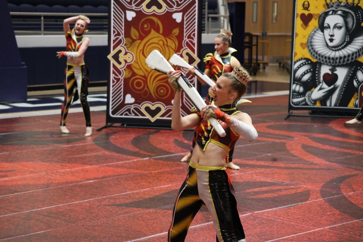 After a successful catch, junior Katelyn Bergh poses with her rifle at the beginning part of her color guard show. The Prosper Winter Guard went to state, becoming a state finalist and placing seventh. “I was very happy with how it ended,” Bergh said. “I think the majority of our team was. It was some of the best runs we could hope for.”