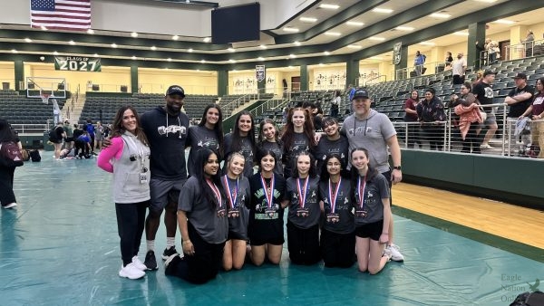 Standing in a group, the Prosper Leady Eagles powerlifting team gathers in the PHS arena. Six lifters medaled at the event, with Dani Espinosa and Ayden Holman qualifying for the state meet. The team finished fifth overall and will return to compete at the state meet later this season.