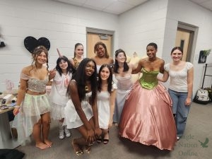 Huddled in their newest outfits, fashion design students prepare to go on stage. Pictured in the photo are student Jaiden Correia, Carolina Reyes, Cora Roberts, Khloe Koan, Lyn Lee, Gabby Jones, Brittanie Green, Samantha Owusu and Giana Ventura. The fashion show took place on April 13 at Walnut Grove high school. “Our fashion show is inspired by flowers,” Green said. “My dress is like a big flower. The bottom (is) the pink petals of a flower. I (felt) prepared, but starting this project and working through it and being done with it on time (was) really hard.”
