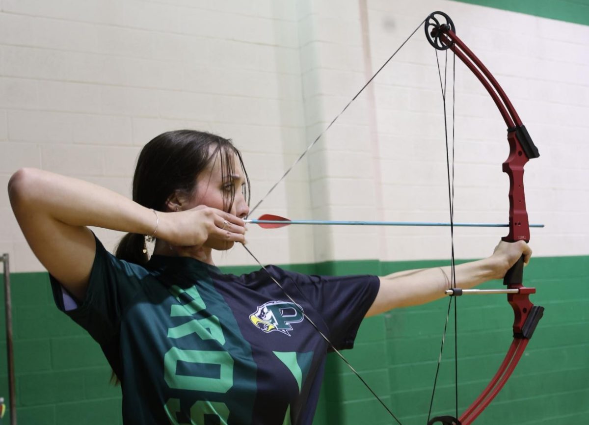 Standing in form, senior Olivia Crooks prepares to hit her target. "I think getting out of my head really improved my score," Crooks said. "Once you start competing with only yourself, you really improve your time."