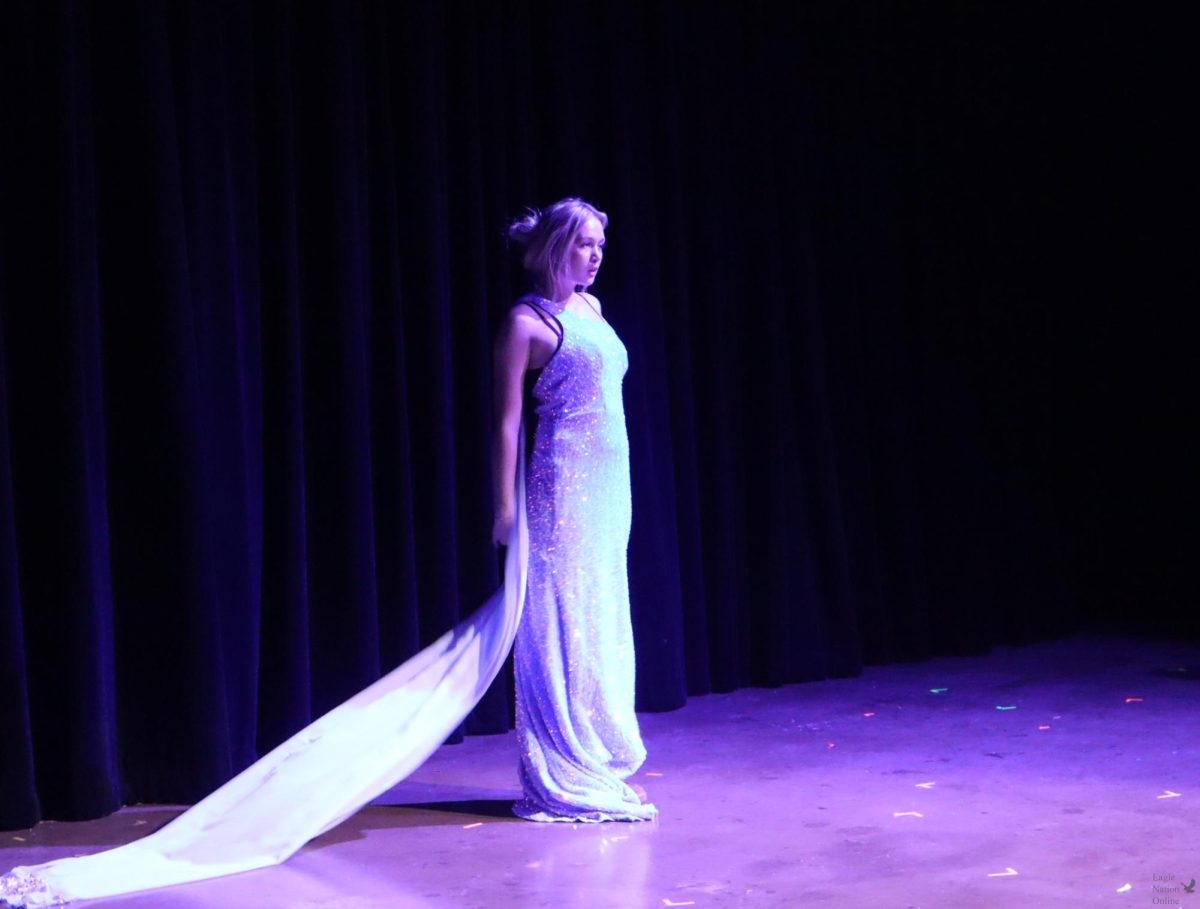 Looking straight ahead, Presley Christensen performs her part. Christensen plays 'Elsa' from 'Frozen' in the Disney Reality Show. The play opened on Feb. 18.