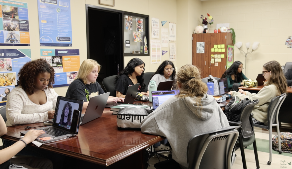 Focused, the yearbook team works on their pages to help complete the book on Mar. 11. There are 11 people on the yearbook team. "As far as what students can expect from distribution, they can expect something similar to last year," Potter said. "They will head to a designated location during their lunch and tell a staffer their last name, sign for the book and then enjoy."
