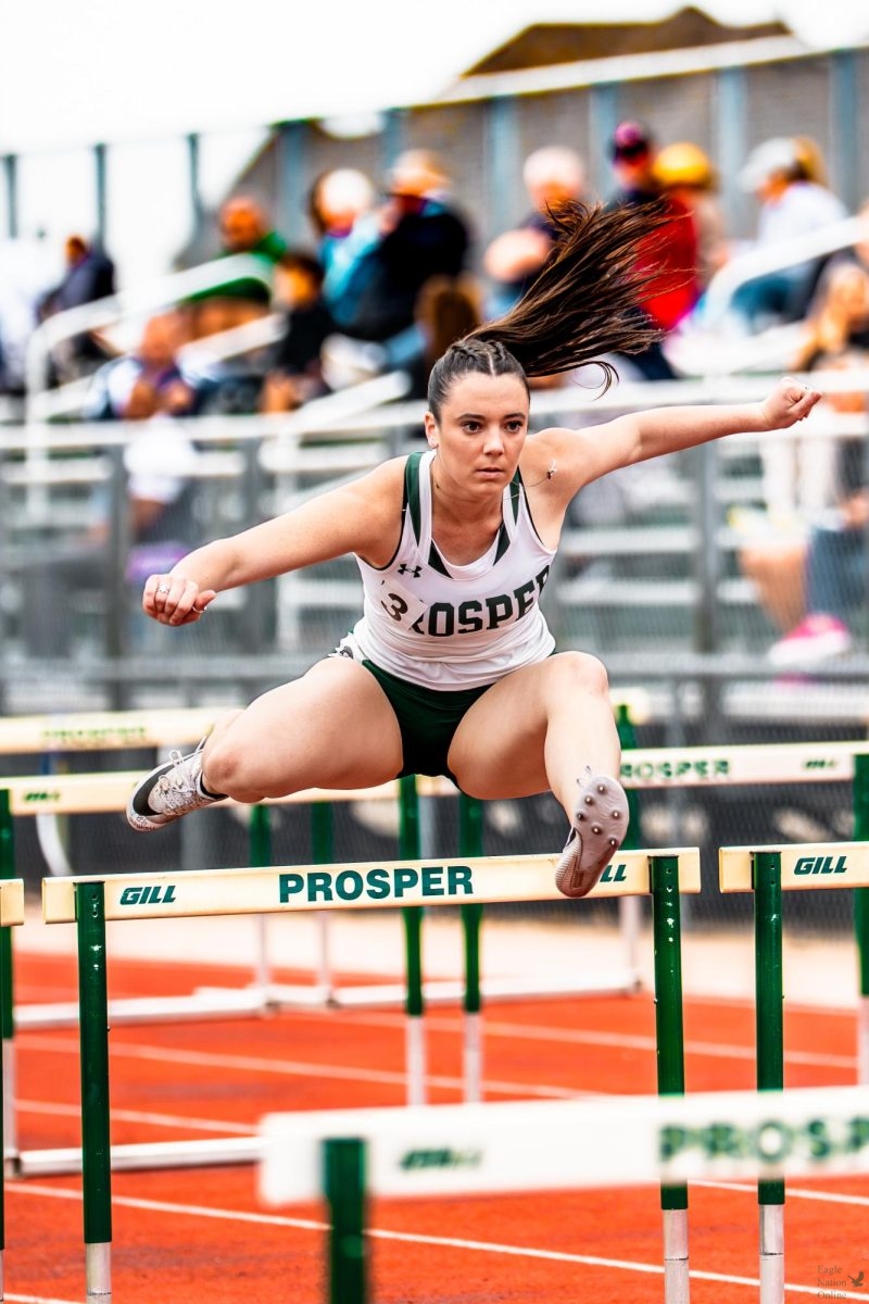 Jumping over a hurdle, junior Riley Kincade focuses on the track. Kincade's primary position is contributing to the 100m High Hurdles team. Members of the Track & Field team competed at the UIL 6A Region 1 Championship from May 1-2 at the University of Texas at Arlington.