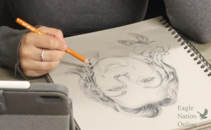 Sketching at a desk, Sapphire Vasquez works on a portrait. Sapphire Vasquez is a substitute teacher for art. "I've enjoyed (the different art) a lot because everybody has a different style, everybody wants different materials," Vasquez said. "They are creating things that they love on top of the things that they probably don't enjoy as much."